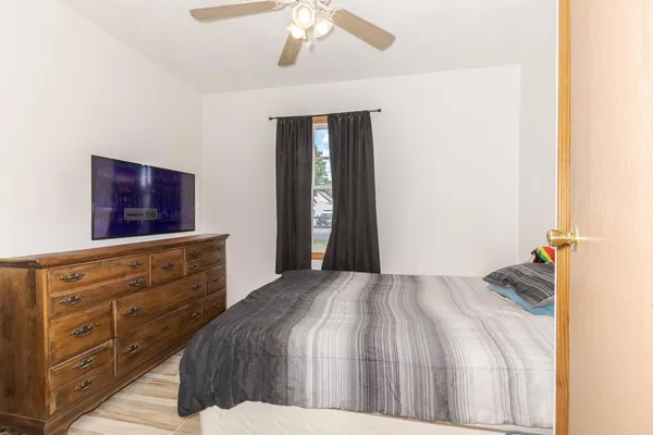 a bedroom with a bed and a dresser