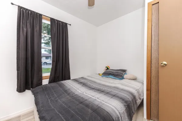 a bedroom with a bed and glass window