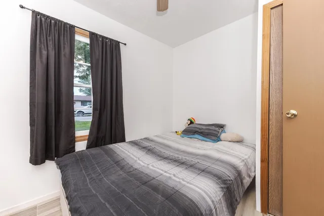 a bedroom with a bed and glass window