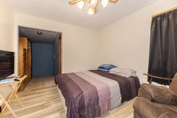 a bedroom with a bed and a flat tv screen