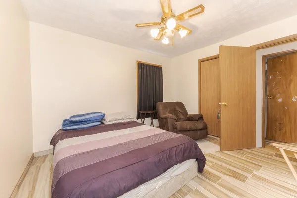 a bedroom with a bed and a chandelier