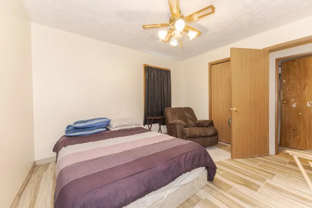 a bedroom with a bed and a chandelier