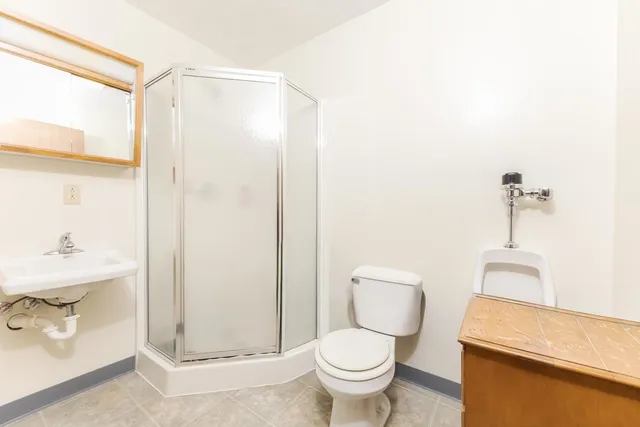 a white toilet sitting next to a bathroom sink