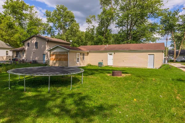 a backyard of a house with table and chairs