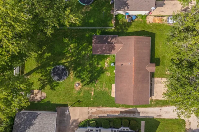 an aerial view of a house with a yard basket ball court and outdoor seating