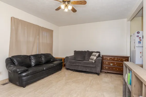 a living room with furniture and a chandelier