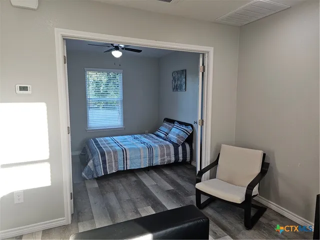 a bedroom with a bed and a window