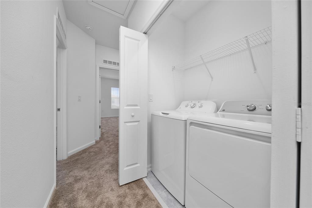 2587 Skyline Loop Kissimmee, FL 34758 - Photo 14 of 27 a utility room with dryer and washer