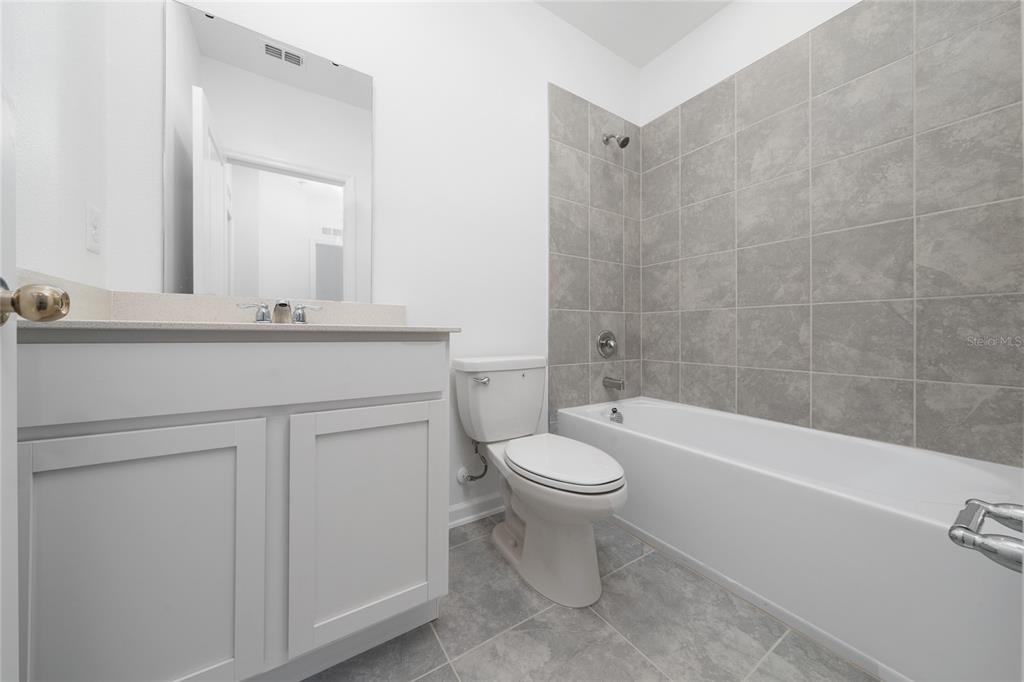 2587 Skyline Loop Kissimmee, FL 34758 - Photo 15 of 27 a bathroom with a sink a toilet and bathtub
