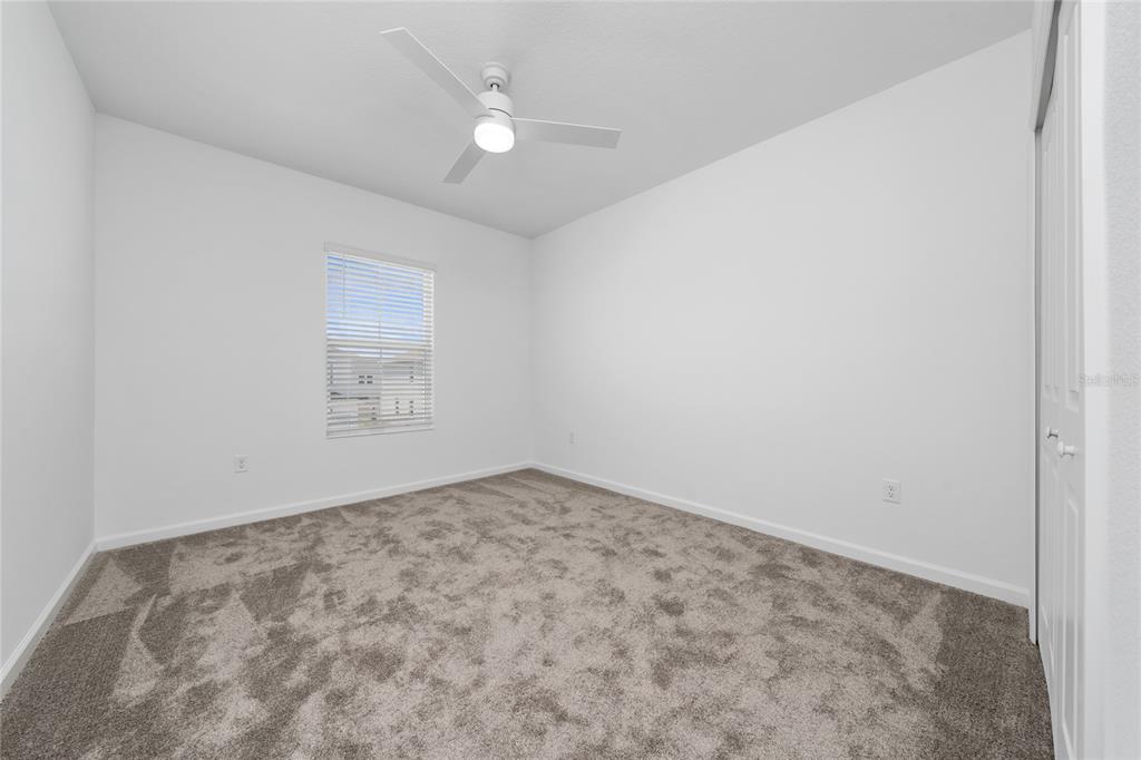 2587 Skyline Loop Kissimmee, FL 34758 - Photo 18 of 27 an empty room with a fan