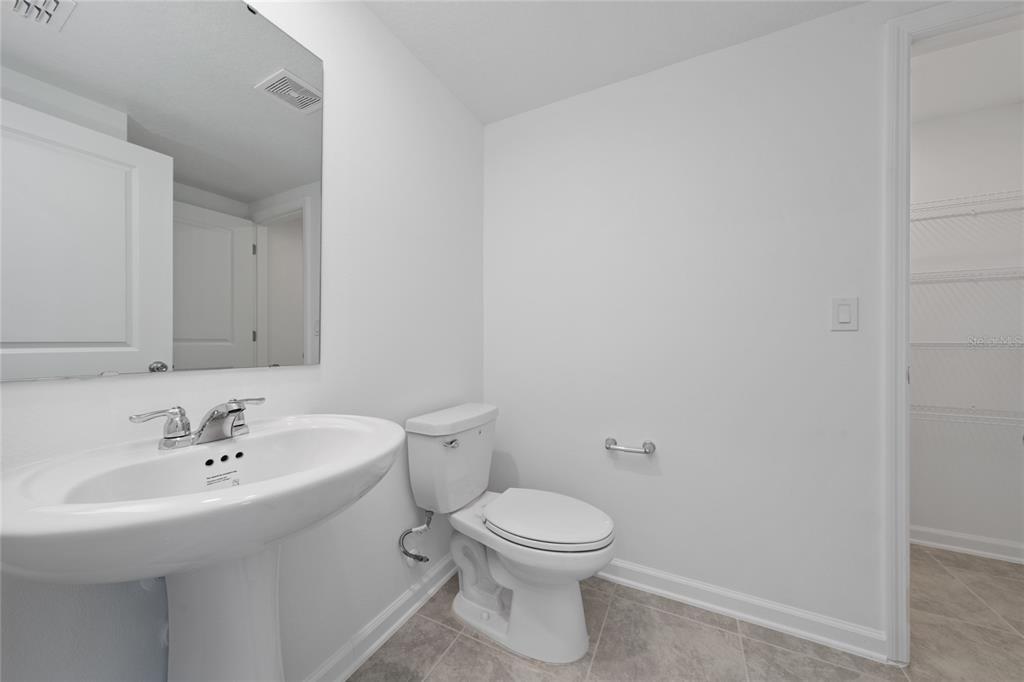 2587 Skyline Loop Kissimmee, FL 34758 - Photo 19 of 27 a white toilet sitting next to a bathroom sink