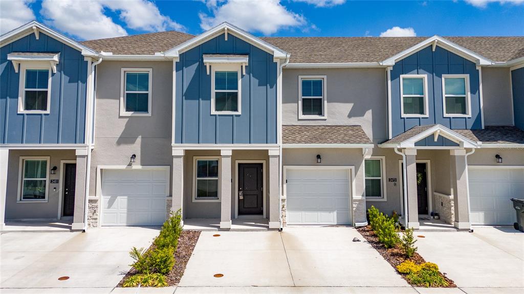 2587 Skyline Loop Kissimmee, FL 34758 - Photo 2 of 27 a front view of a house with a garden