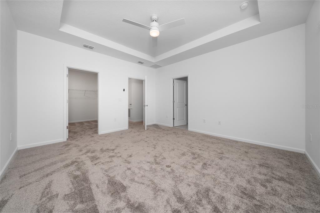 2587 Skyline Loop Kissimmee, FL 34758 - Photo 24 of 27 an empty room with a ceiling fan and closet area