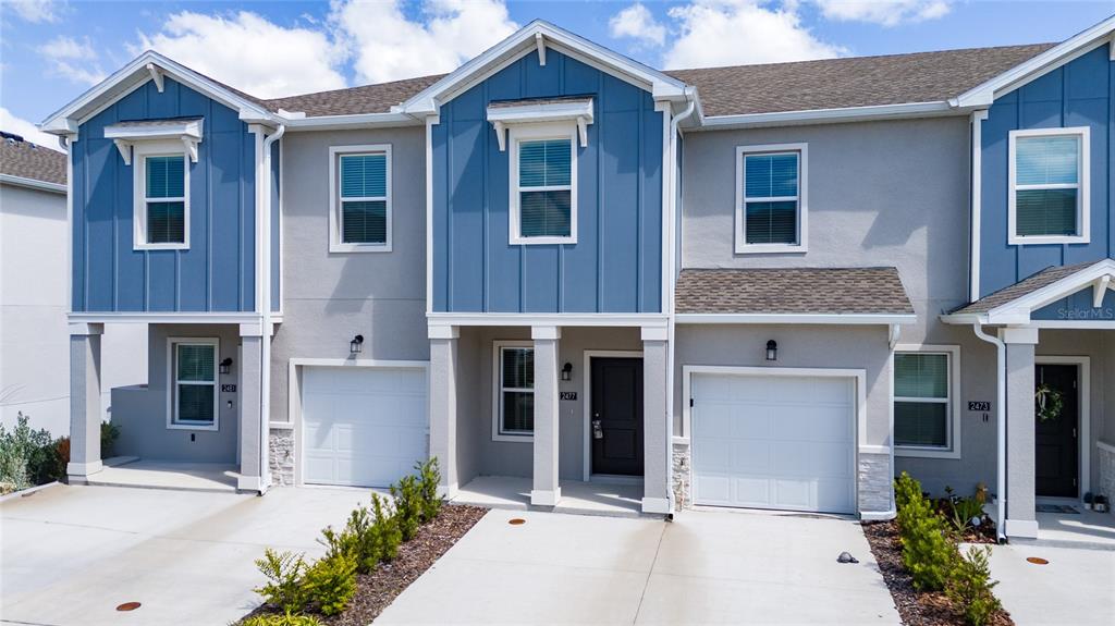 2587 Skyline Loop Kissimmee, FL 34758 - Photo 3 of 27 a front view of a house with a yard