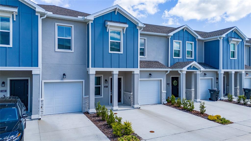 2587 Skyline Loop Kissimmee, FL 34758 - Photo 4 of 27 a front view of a house with a yard