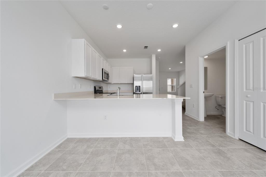 2587 Skyline Loop Kissimmee, FL 34758 - Photo 6 of 27 a view of kitchen with white cabinets