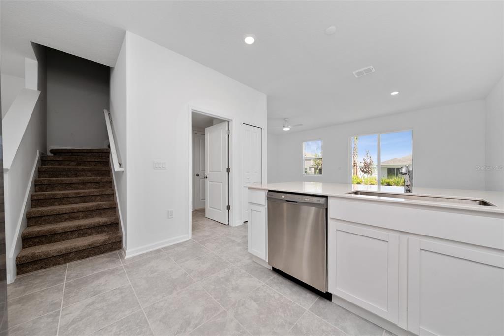 2587 Skyline Loop Kissimmee, FL 34758 - Photo 9 of 27 a kitchen with white cabinets and white appliances
