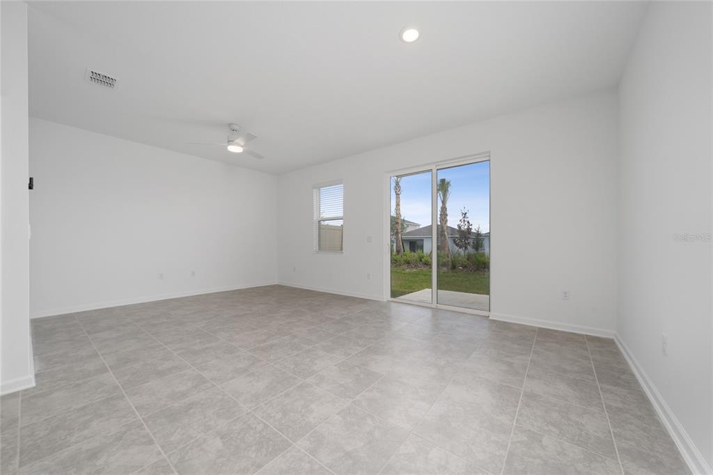 2587 Skyline Loop Kissimmee, FL 34758 - Photo 10 of 27 a view of an empty room with a window