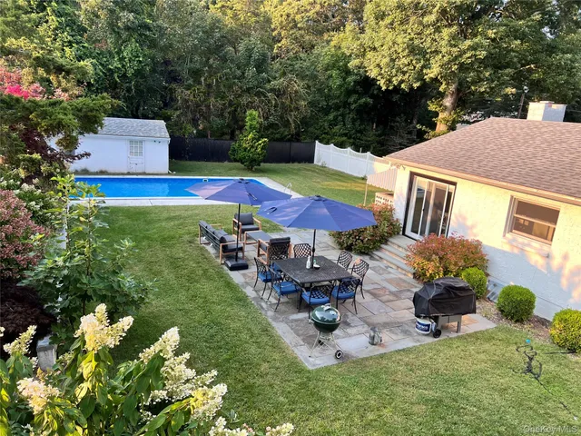 a view of a house with backyard porch and sitting area