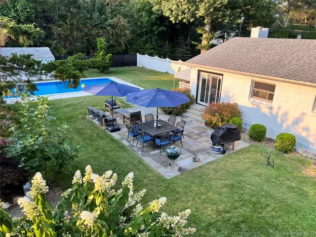 a view of a house with swimming pool garden and patio