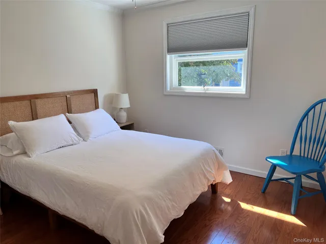 a bedroom with bed and a window