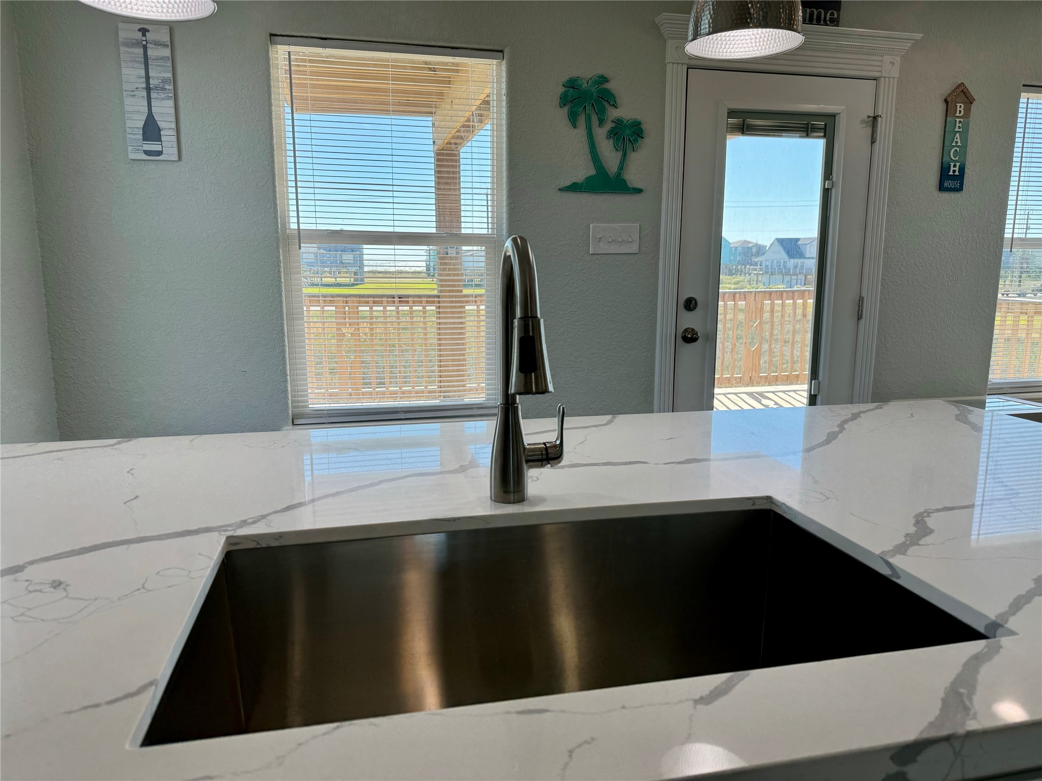 4822 Palm Street Surfside Beach, TX 77541 - Photo 12 of 32 Imagine washing dishes at the sink in the bright and airy kitchen while looking out the windows.