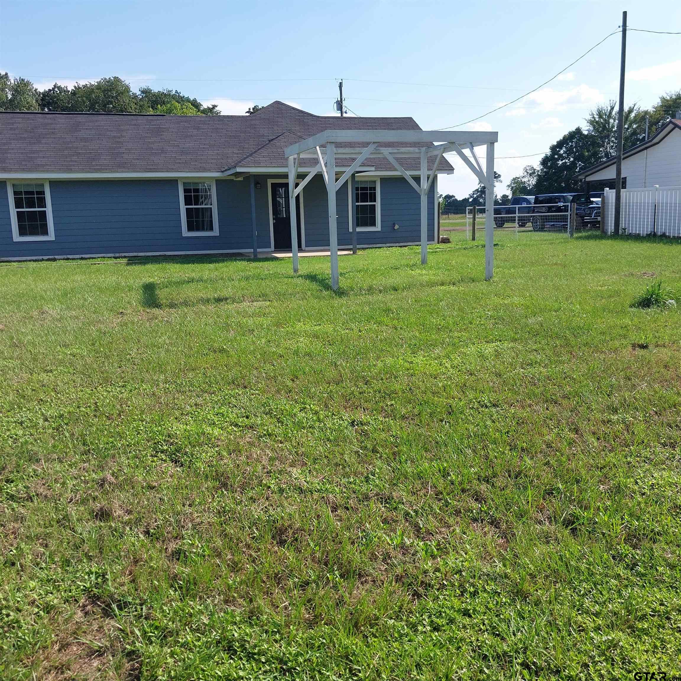 1937 Highway 11 Pittsburg, TX 75686 - Photo 22 of 33 a front view of a house with a yard