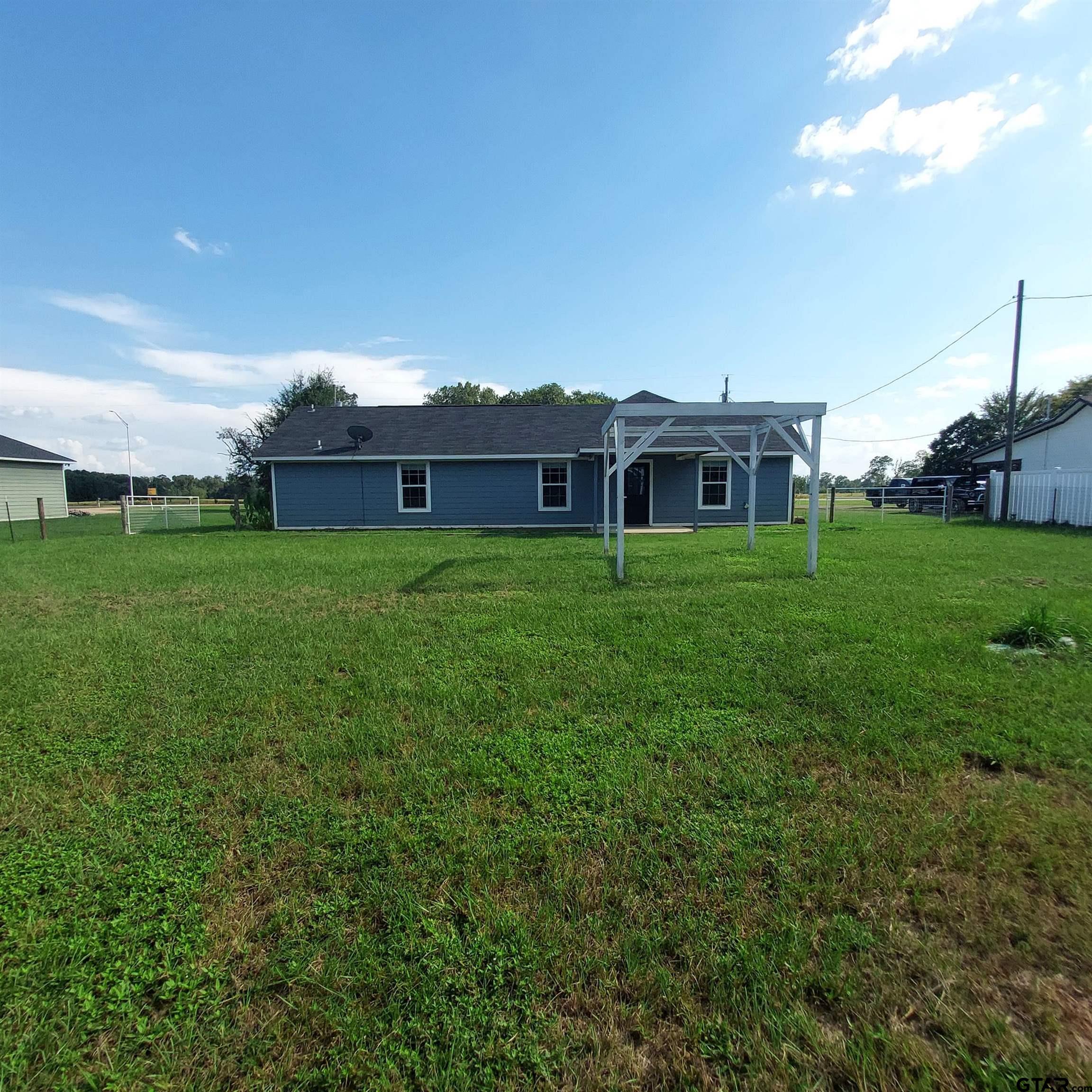 1937 Highway 11 Pittsburg, TX 75686 - Photo 23 of 33 a front view of a house with a yard and trees