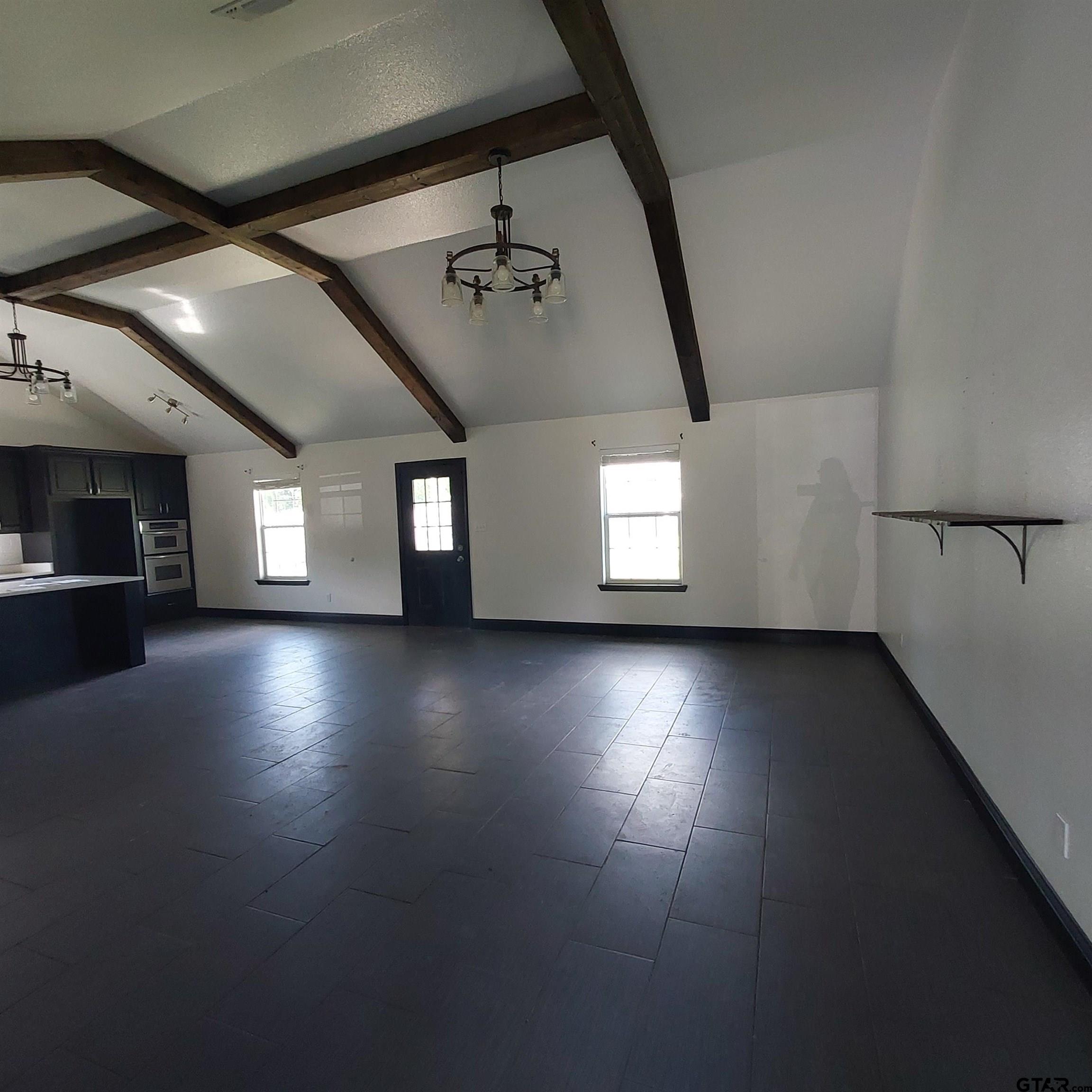 1937 Highway 11 Pittsburg, TX 75686 - Photo 5 of 33 an empty room with hard wood floors and windows