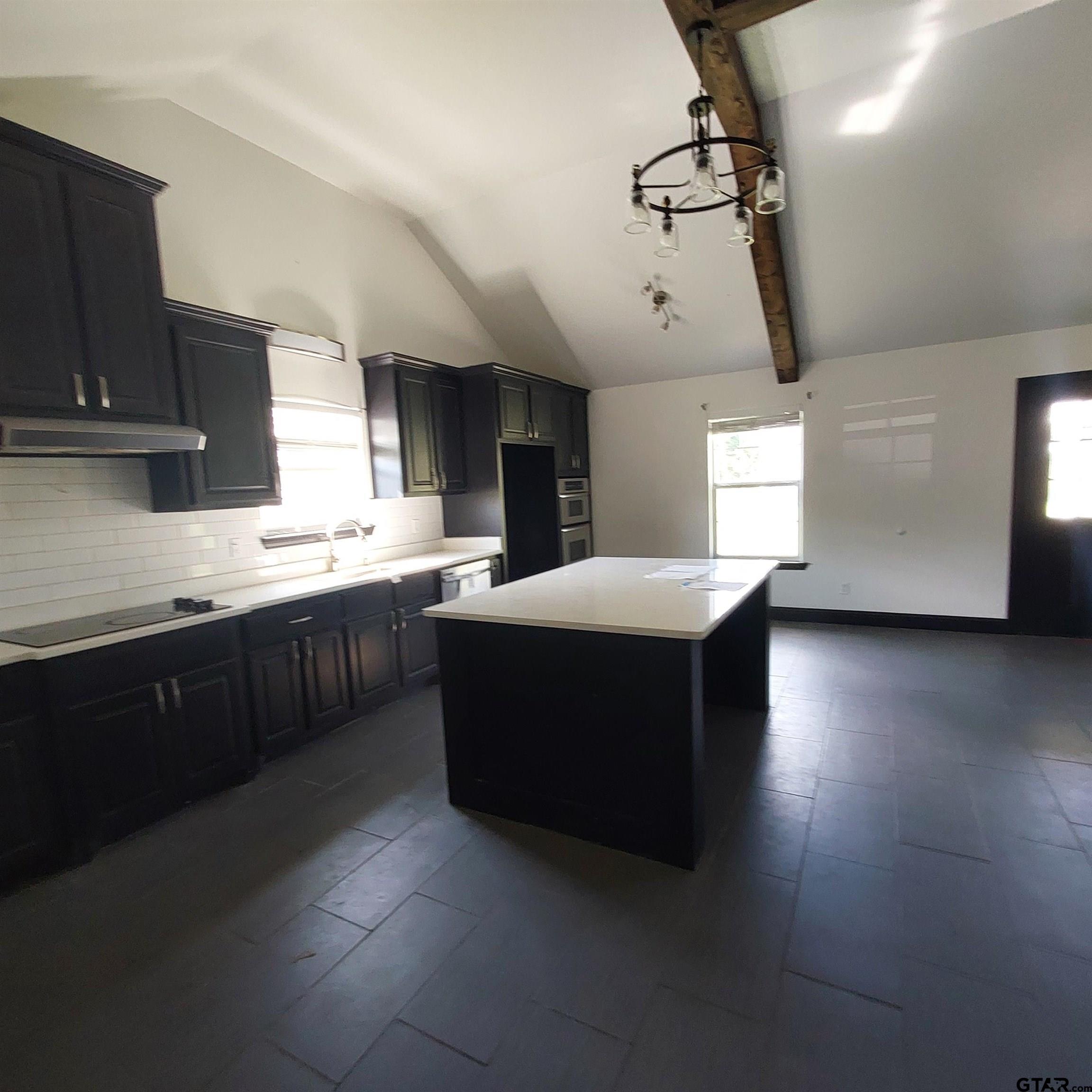 1937 Highway 11 Pittsburg, TX 75686 - Photo 7 of 33 a large kitchen with stainless steel appliances a sink a counter space and cabinets