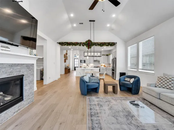 a kitchen with furniture a large window and a fireplace