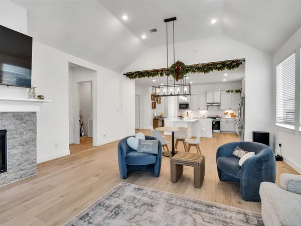 a living room with furniture fireplace and flat screen tv