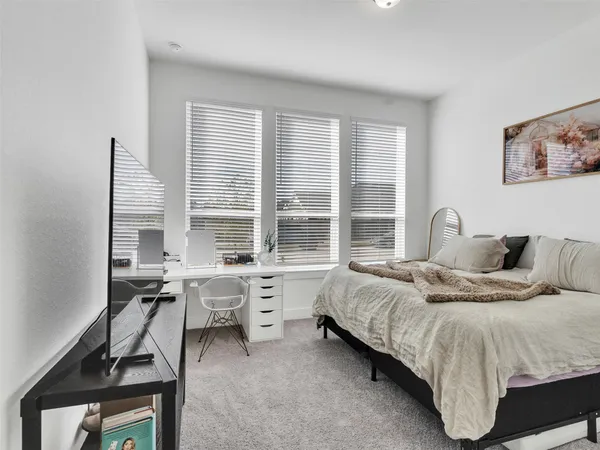 a bed room with furniture and a large window