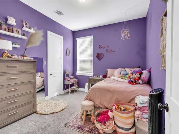 a bedroom with a bed and a dresser