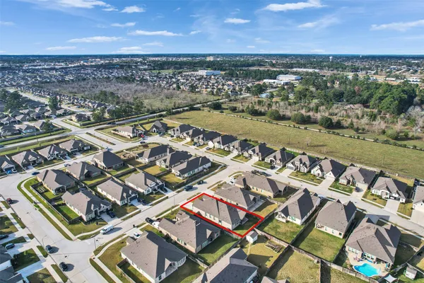 an aerial view of a city with lots of residential buildings and ocean view