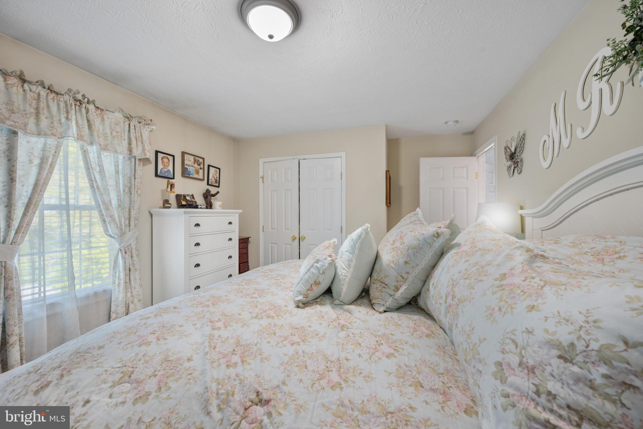 407 Freeze Road Linden, VA 22642 - Photo 13 of 28 Serene bedroom with floral accents.