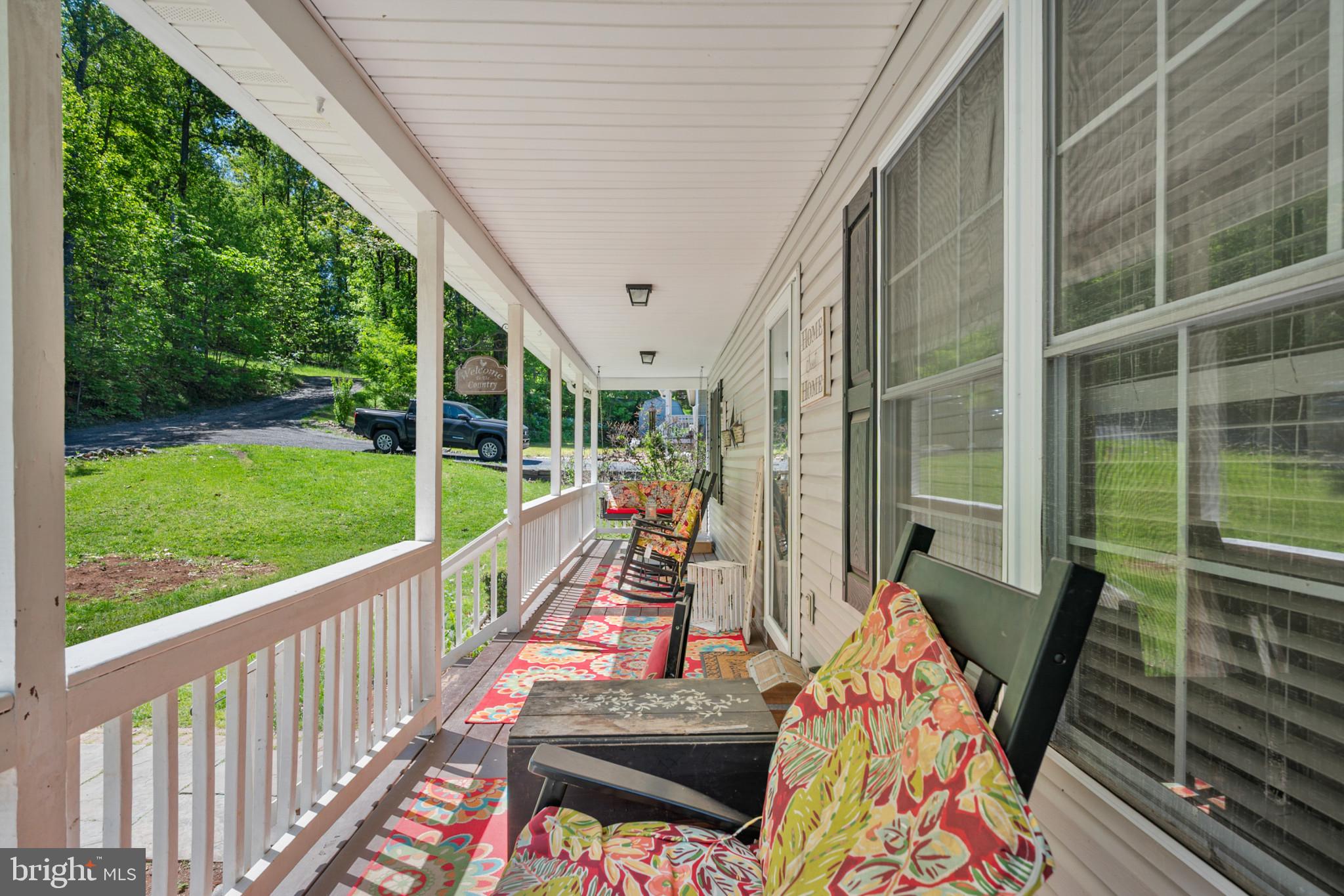 407 Freeze Road Linden, VA 22642 - Photo 4 of 28 Charming porch with lush greenery views.