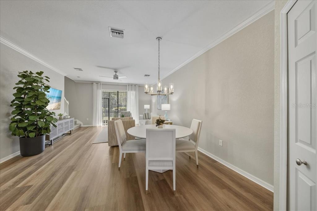 7224 Ketch Place Bradenton, FL 34212 - Photo 13 of 70 a dining room with furniture potted plants and wooden floor