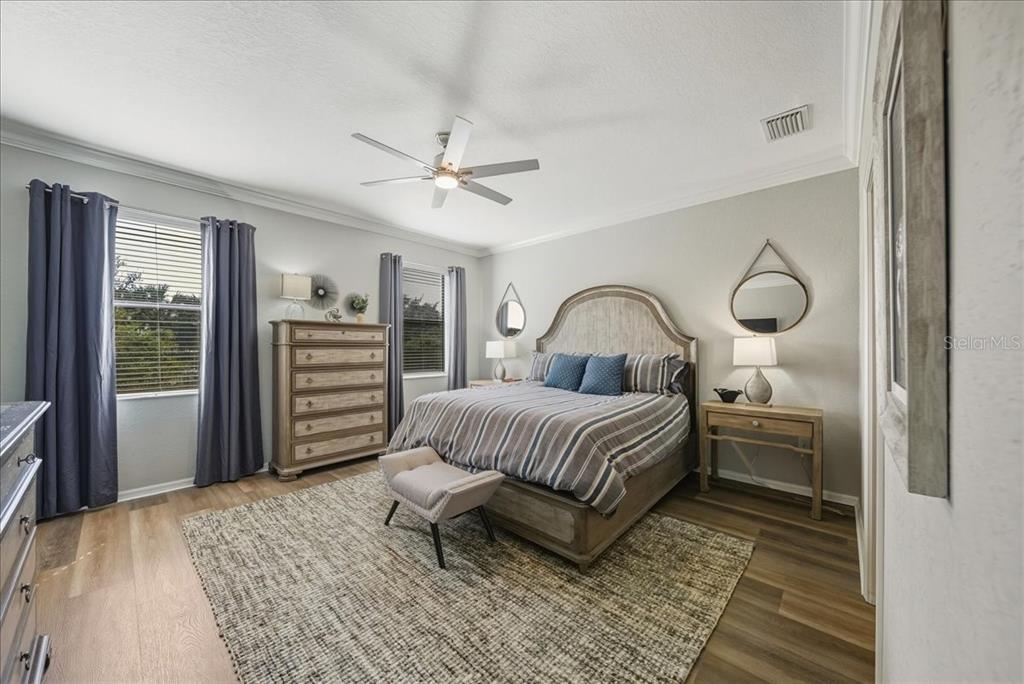 7224 Ketch Place Bradenton, FL 34212 - Photo 32 of 70 a bedroom with a bed and a chandelier