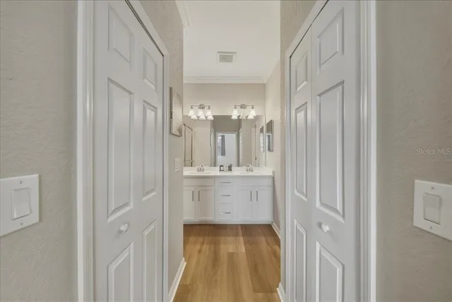 a bathroom with a sink a mirror and a light fixture