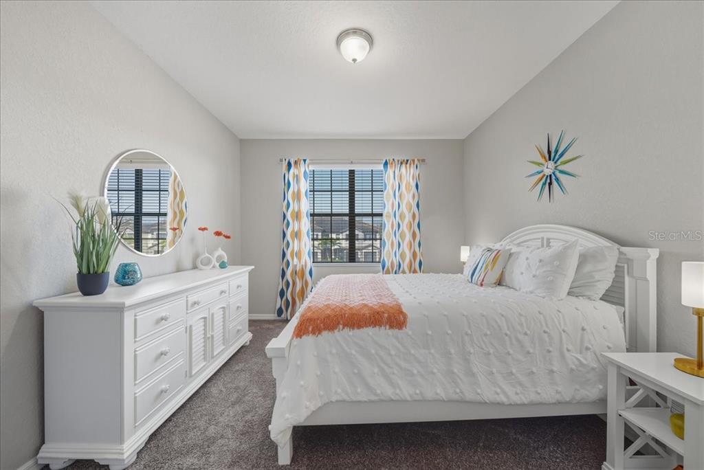 7224 Ketch Place Bradenton, FL 34212 - Photo 39 of 70 a bedroom with a bed and a chandelier