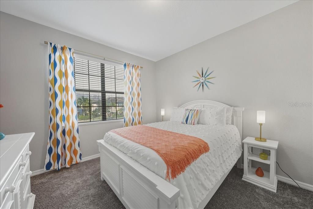 7224 Ketch Place Bradenton, FL 34212 - Photo 43 of 70 a bedroom with a bed and a chandelier