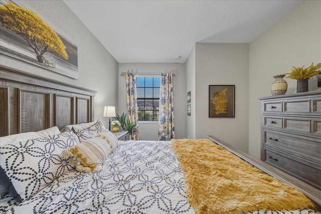 7224 Ketch Place Bradenton, FL 34212 - Photo 45 of 70 a bedroom with a bed and dresser with mirror