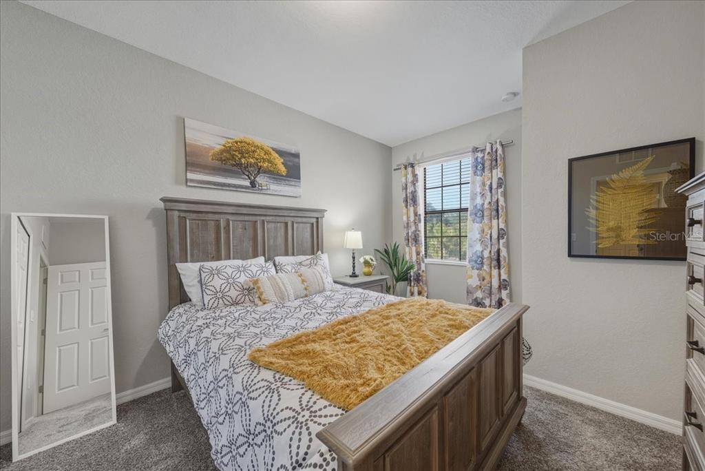 7224 Ketch Place Bradenton, FL 34212 - Photo 46 of 70 a bed sitting in a bedroom next to a window