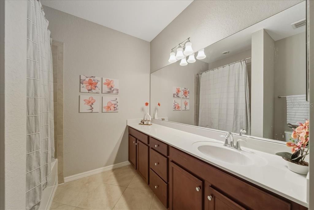 7224 Ketch Place Bradenton, FL 34212 - Photo 49 of 70 a bathroom with a double vanity sink and a mirror