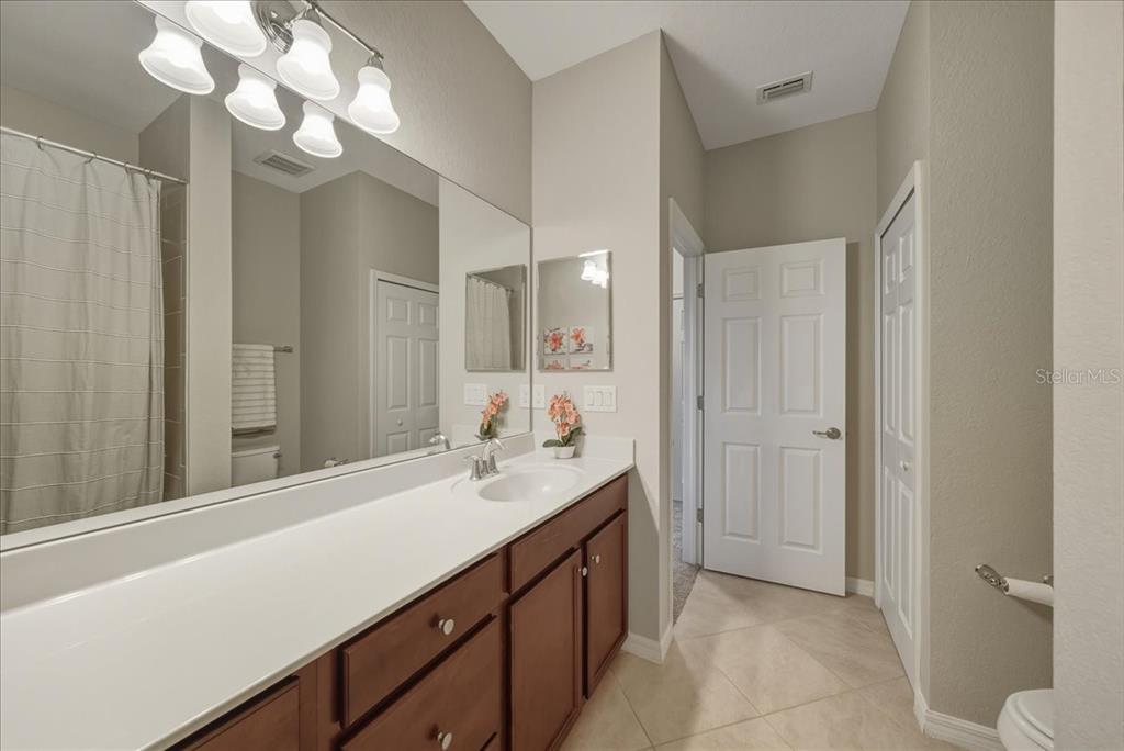7224 Ketch Place Bradenton, FL 34212 - Photo 51 of 70 a bathroom with a sink a mirror and a light fixture