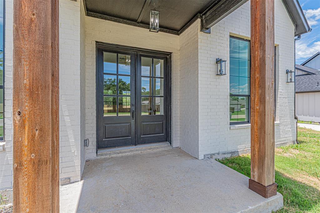 360 Dalton Road Canton, TX 75103 - Photo 2 of 33 Entryway featuring double black French doors, white brick exterior, natural wood-finish support columns, and black exterior light fixtures