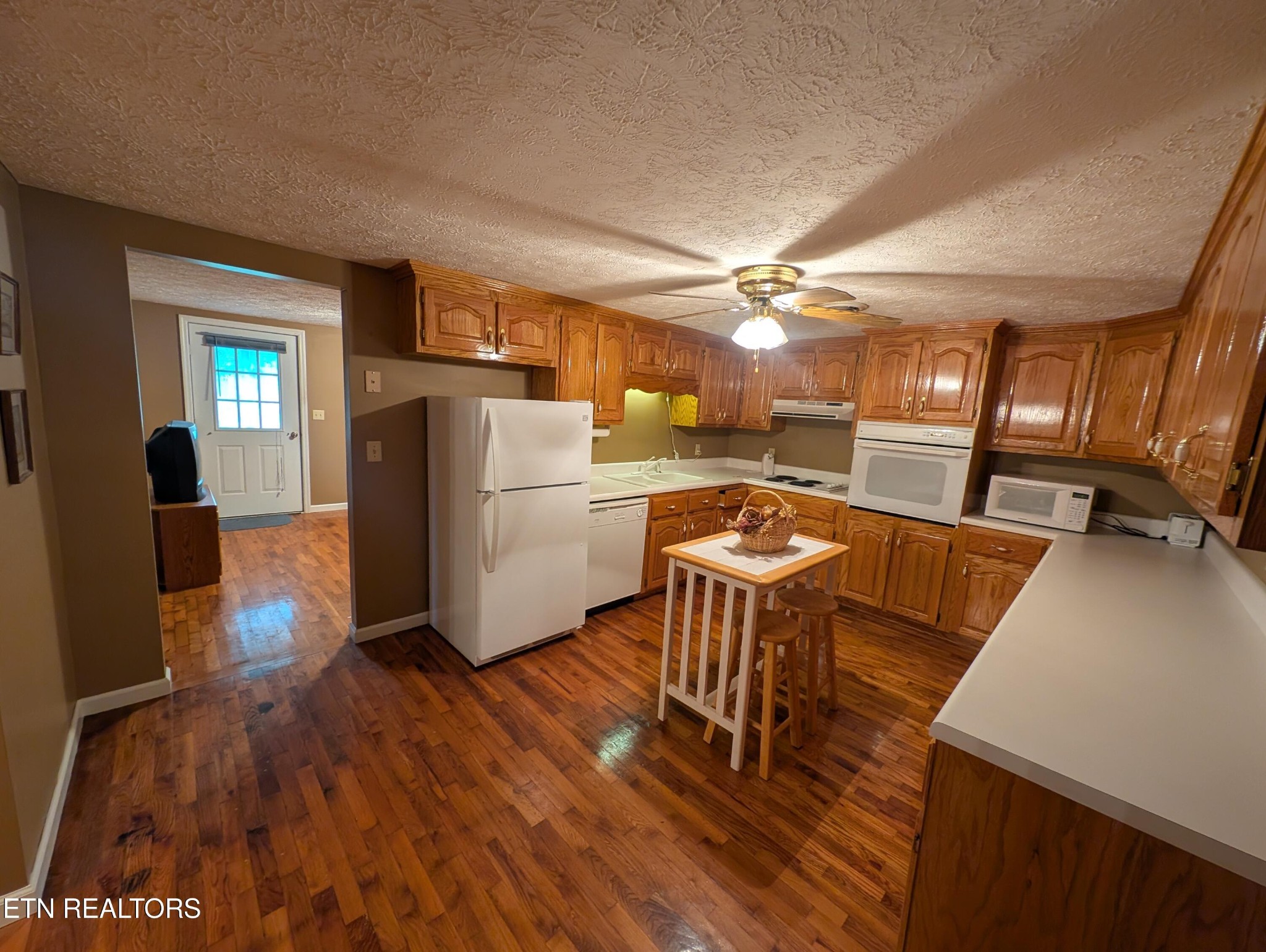 1729 Roslin Road Jamestown, TN 38556 - Photo 18 of 49 a kitchen with a table chairs refrigerator and a wooden cabinets