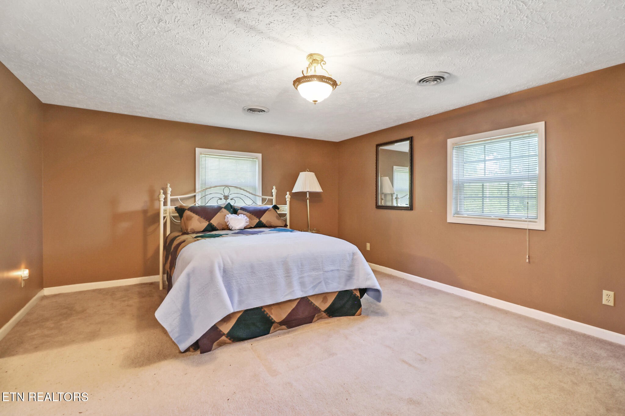 1729 Roslin Road Jamestown, TN 38556 - Photo 25 of 49 a bedroom with a bed and a chandelier