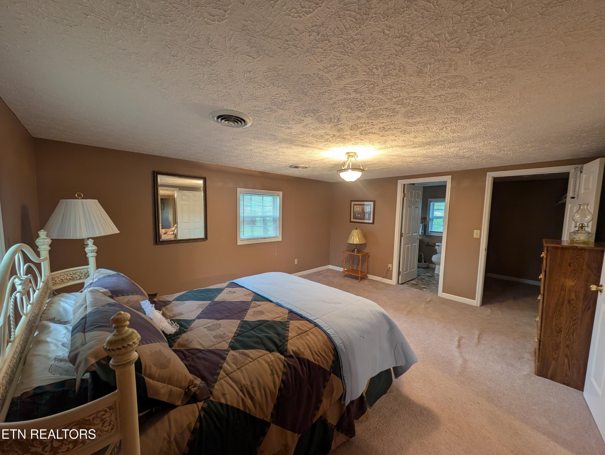 1729 Roslin Road Jamestown, TN 38556 - Photo 27 of 49 a spacious bedroom with a bed and a lamp
